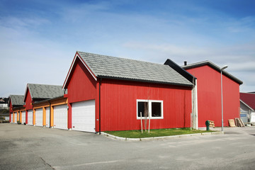 Fototapeta na wymiar Traditional rural red and yellow wooden Norwegian garages