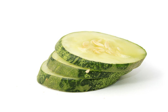 Sliced cucumber over white background