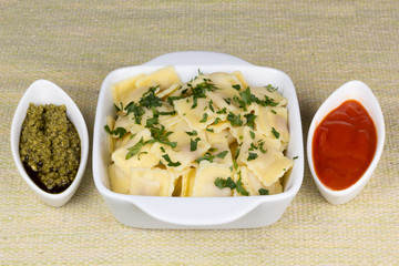 Italian pasta, ravioli with parsley and sauces