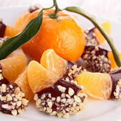tangerine or mandarin fruit with chocolate sauce