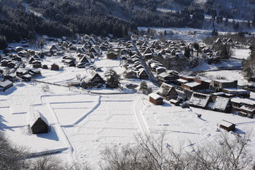 Thatched roof houses covered in snow in winter