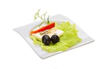 Soft cheese on salad with olives