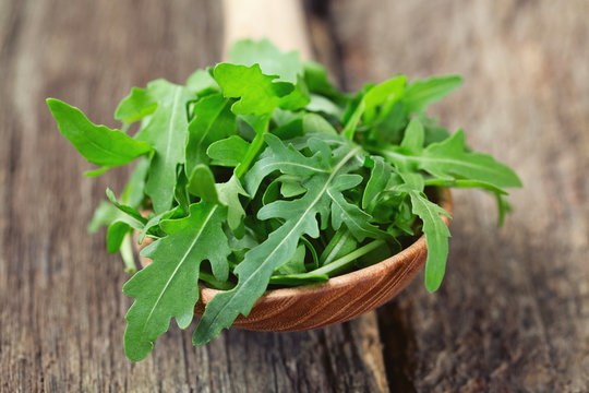 rucola in a wooden spoon