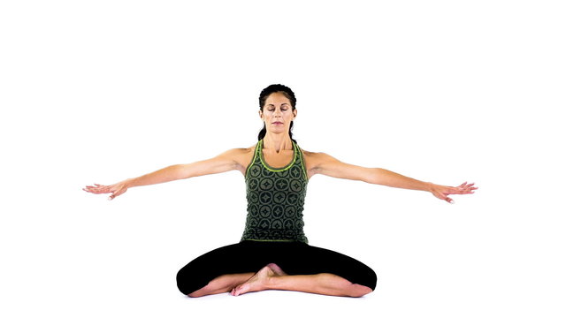 young woman practices yoga moves in studio