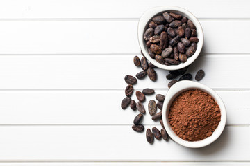 cocoa beans and cocoa powder in bowls