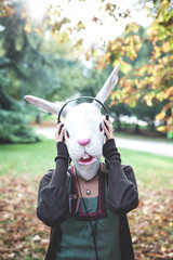 rabbit mask woman listening to music