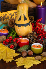 Composition for Halloween with pumpkins and candles close-up