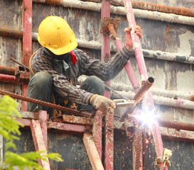 Worker welding on the bridge high.