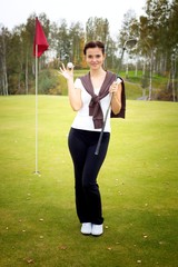 Happy and smiling woman golf player in winner pose