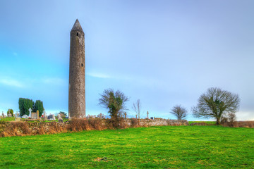 Kilmacduagh monastery with stone tower in Ireland