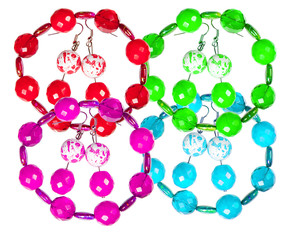 Earrings and bracelets made of plastic and glass on a white back