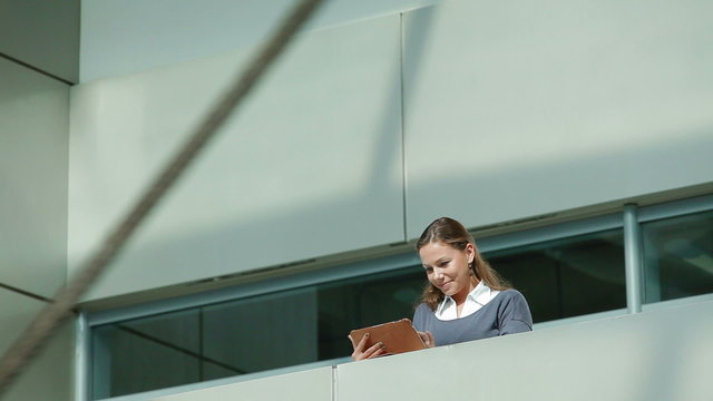 business woman with tablet computer in office building