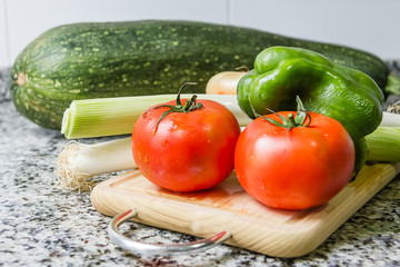 Fresh vegetables on cutting board in the kitchen