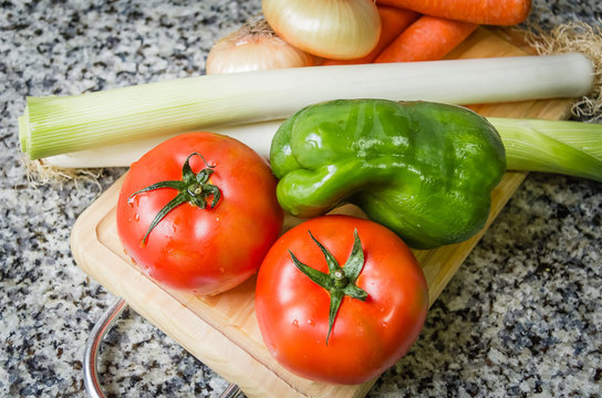 Fresh vegetables on cutting board in the kitchen