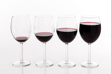 Glasses with different quantities of red wine