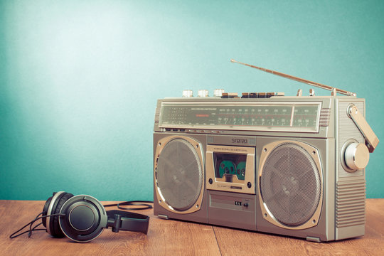 Retro cassette ghetto blaster and headphones in front mint green