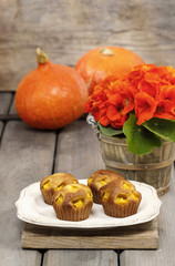Pumpkin muffins on wooden table in autumn setting. Halloween