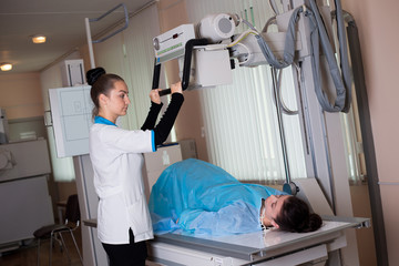 A female doctor operation an x-ray machine in a clinic