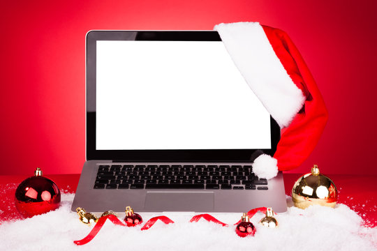 Laptop With Santa Hat - Powered by Adobe