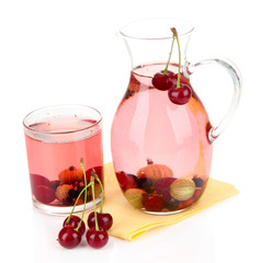 Pitcher of compote with summer berries isolated on white