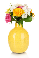 Beautiful bouquet of bright flowers in color vase, isolated