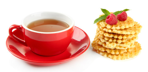 Cup of tea with cookies and raspberries isolated on white