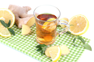 Cup of tea with ginger on napkin isolated on white