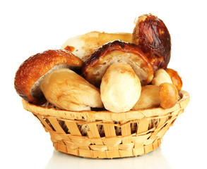 Fresh mushrooms in basket isolated on white