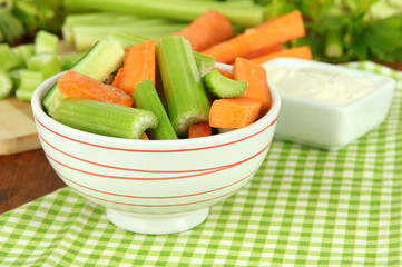 Fresh green celery with vegetables in bowl on table close-up