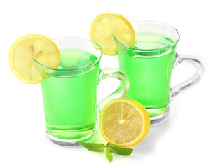 Two transparent cups of green tea with mint and lemon isolated