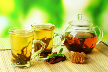 Cup and teapot of green tea with honey