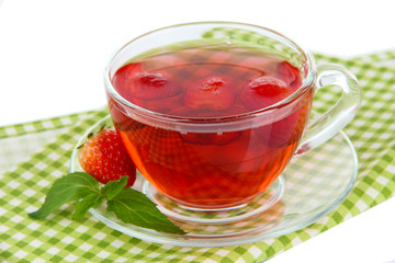 Delicious strawberry tea on table on white background