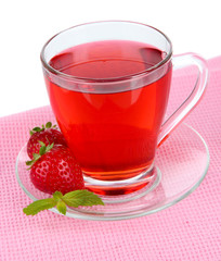 Delicious strawberry tea on table on white background