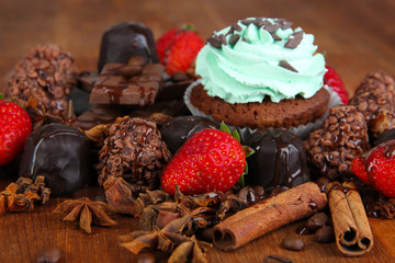 Tasty cupcake with different sweets close up