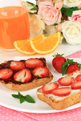 Delicious toast with strawberry on plate close-up