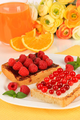 Delicious toast with berries on table close-up