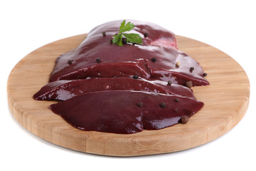 Raw liver on wooden board isolated on white