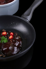 Raw liver in pan on cooking surface close-up