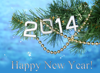 2014 hang on Christmas tree close-up on blue background