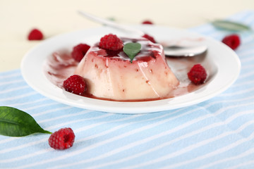 Panna Cotta with raspberry sauce, on wooden background