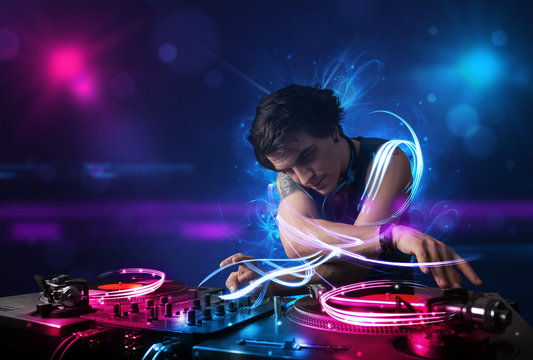 Disc jockey playing music with electro light effects and lights