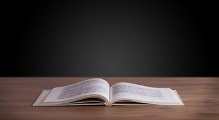 Open book on wooden deck