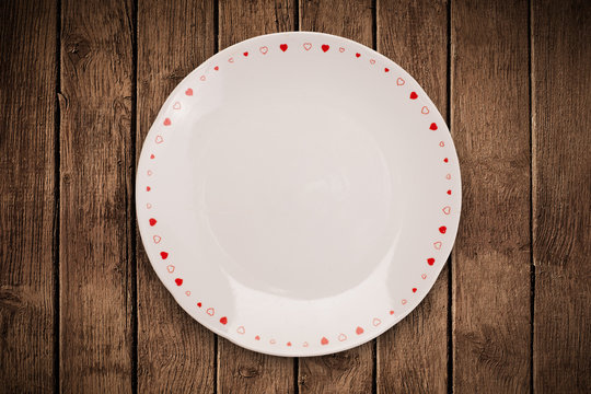 Colorful empty plate on grungy background table