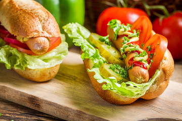 Closeup of two  homemade hot dog with fresh vegetables