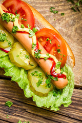 Closeup of homemade hot dog with a lot of vegetables