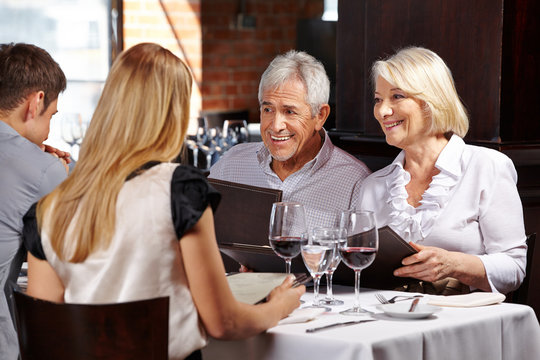 Senior Couple With Family In Restaurant