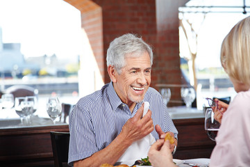 Elderly man with napkin at restaurant