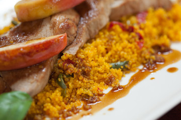 Close up of couscous with meat and apple