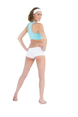 Naklejka premium Pretty slender woman looking over her shoulder at camera wearing