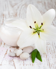 Fototapeta na wymiar Face cream with lily flowers